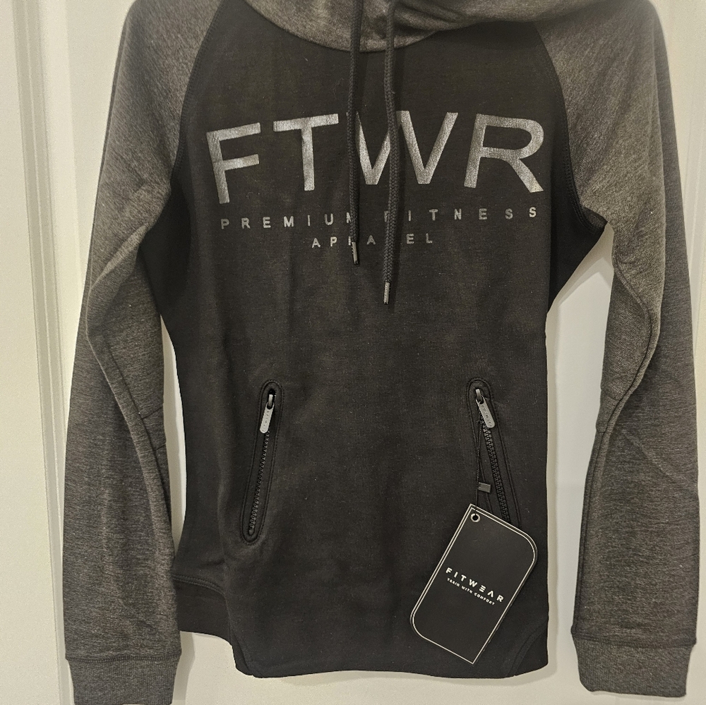 WOMEN'S FITWEAR BLACK HOODIE WITH TWO ZIPPERED POCKETS IN FRONT. NWT.